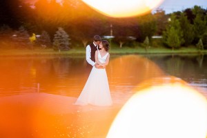 bride and groom on lake